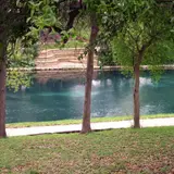 Scenic view of the Comal River in New Braunfels, Texas, lined with trees