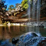 Hamilton Pool Preserve, with its waterfall cascading into a turquoise swimming hole beneath a limestone overhang