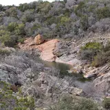 Scenic overlook view of Devil's Waterhole and the surrounding hills at Inks Lake State Park