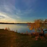 A warm sunset over Inks Lake's fall foliage
